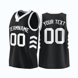 May include: Black basketball jersey with white accents. The front of the jersey has the text "TEAMNAME" and the number "00" with a chevron pattern on the side. The back of the jersey has the text "YOUR TEXT" and the number "00".