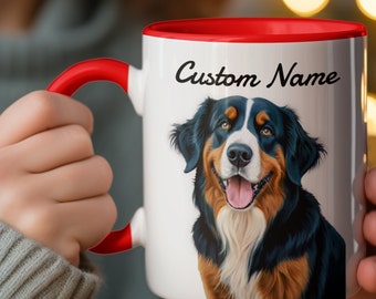 May include: White ceramic mug with a red rim and handle. The mug features a colorful illustration of a Bernese Mountain Dog with the text "Custom Name" printed on the mug.