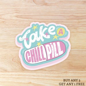 May include: A sticker with the words "Take a Chill Pill" in white and pink, with a light blue and pink background. The sticker has a pill shape and star accents.