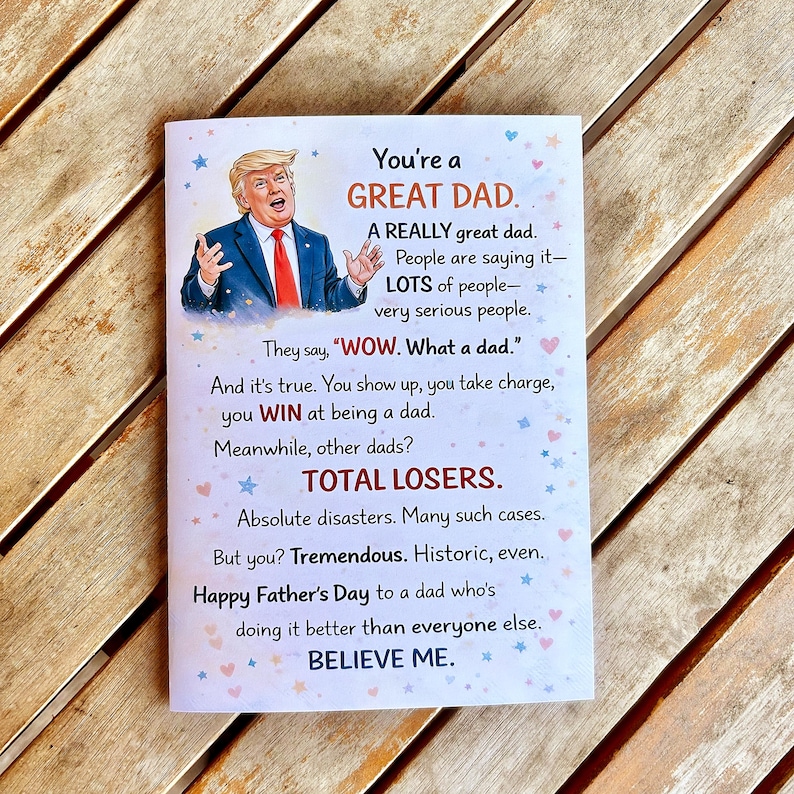 May include: A Father's Day greeting card with a picture of a man in a suit and tie. The card has text that reads "You're a GREAT DAD" and other phrases. The card is white with blue and pink star accents.