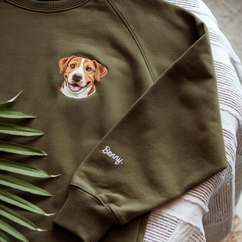 May include: A green sweatshirt with an embroidered image of a dog and the name "Benny" on the sleeve.