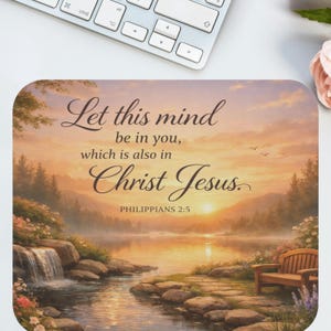 May include: A rectangular mousepad featuring a scenic landscape with a lake, waterfall, and bench. The image has a sunset with the text "Let this mind be in you, which is also in Christ Jesus. Philippians 2:5."