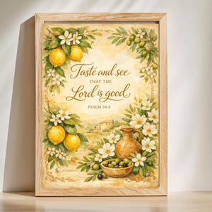 May include: A framed wall art print featuring a watercolor illustration of lemons, white blossoms, and olives. The text reads: Taste and see THAT THE Lord is good. PSALM 34:8. A terracotta pitcher and a bowl of olives sit in the foreground.