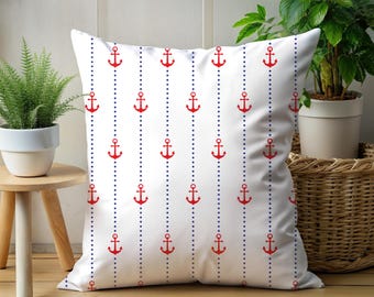 May include: White square pillow with a nautical pattern of red anchors and blue dotted lines. The anchors are evenly spaced and arranged vertically on the pillow's surface. The pillow is a decorative item.