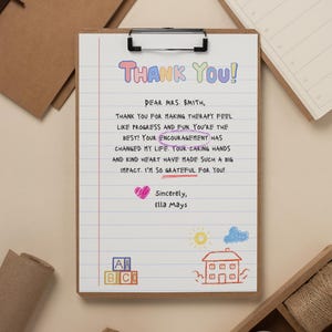 May include: A wooden clipboard holds a handwritten thank you note with colorful text. The note reads "Thank You!" and expresses gratitude to Mrs. Smith. Decorative elements include a heart, sun, house, and ABC blocks.