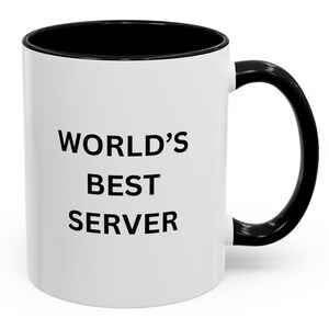 May include: White ceramic mug with a black rim and handle. The mug has the text "WORLD'S BEST SERVER" printed in black.