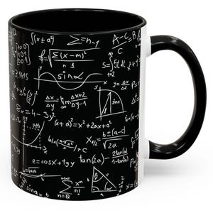 May include: A black coffee mug with a white handle. The mug is covered in white mathematical equations and formulas.