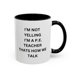Può includere: Tazza in ceramica bianca con interno e manico neri. La tazza presenta il testo "I'M NOT YELLING I'M A P.E. TEACHER THATS HOW WE TALK" in nero, centrato sul davanti. La tazza è progettata per gli insegnanti.
