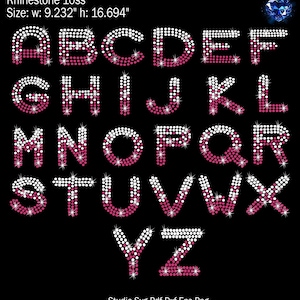 May include: A full alphabet of rhinestone letters in pink and white. Each letter is made of small, round rhinestones. The letters are arranged in three rows. The letters are 9.232 inches wide and 16.694 inches high.