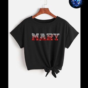May include: Black t-shirt with the name "MARY" spelled out in red and white rhinestones.