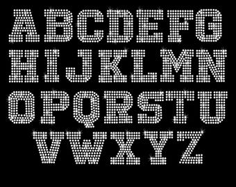 May include: A full alphabet of uppercase letters made from white rhinestones. The letters are arranged in three rows. The letters are 16.204 inches wide and 10.318 inches high.
