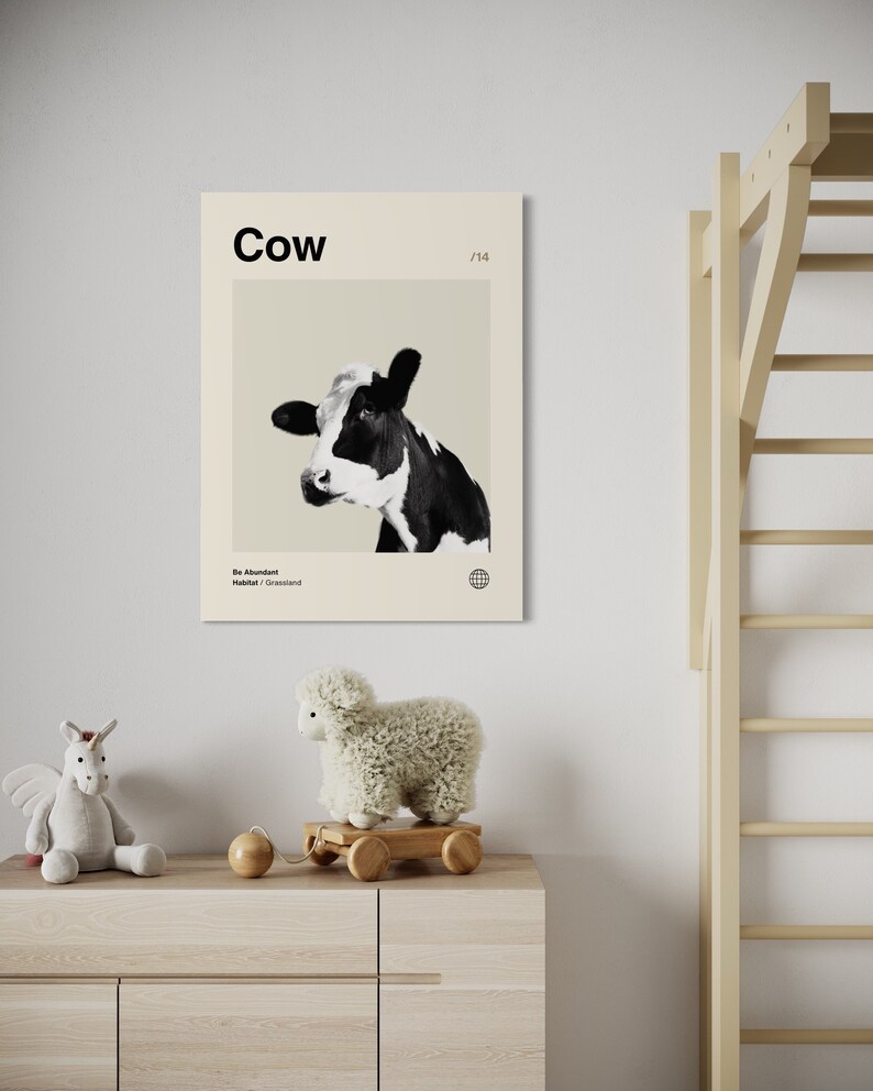May include: A black and white cow with a beige background. The poster has the word "Cow" in black text at the top and the text "Be Abundant" and "Habitat: Grassland" in smaller black text at the bottom. The poster has a number "1/14" in the top right corner.