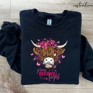 a black shirt with a cow's head on it