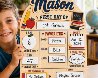 May include: A wooden arched sign for the first day of school featuring the name Mason in dark blue script. The board includes sections for grade, age, height, favorites, date, future career, teacher name, and hobbies with colorful school-themed icons.