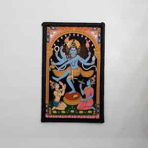 May include: A rectangular patch featuring a detailed illustration of a blue deity with multiple arms, surrounded by figures in traditional attire. The artwork is framed by a black border.