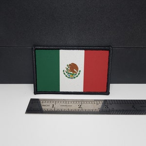 May include: Rectangular patch featuring the Mexican flag, with green, white, and red vertical stripes. The white stripe includes the Mexican coat of arms. The patch is bordered with black stitching and measures approximately 3 inches wide.