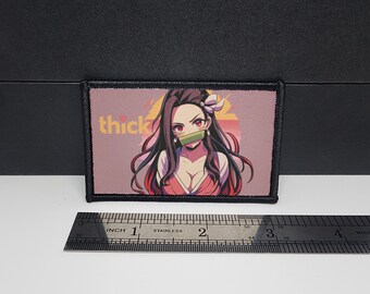 May include: A rectangular patch featuring an anime-style illustration of a female character with long dark hair, red eyes, and a bamboo muzzle. The patch has the word "thick" in pink. The patch is approximately 3 inches long.