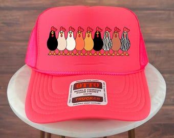May include: A bright pink trucker hat featuring a row of cartoon chickens in various colors. The hat has a mesh back and a snap closure. The front of the hat has the text "OTTO WORLD FAMOUS FOAM FRONT TRUCKER".