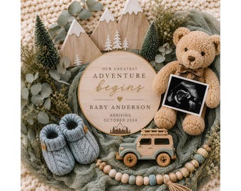 May include: A round wooden sign with the text OUR GREATEST ADVENTURE begins BABY ANDERSON ARRIVING OCTOBER 2024, a tan teddy bear holding an ultrasound scan, blue knit baby booties, a wooden toy SUV, miniature pine trees, and wooden mountain cutouts.