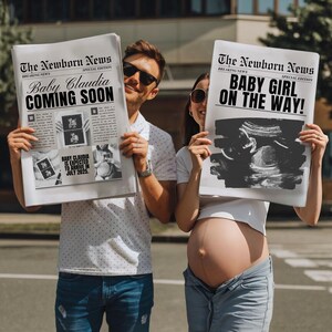 May include: A couple holding up two newspaper-style announcements. The first announcement reads "The Newborn News" with the headline "Baby Claudia Coming Soon". The second announcement reads "The Newborn News" with the headline "Baby Girl On The Way!"