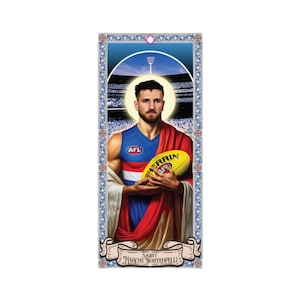 May include: A religious-themed print featuring a portrait of Marcus Bontempelli, an Australian Rules Football player, holding a football. He is wearing a red, white, and blue jersey with the words "AFL" on the front. The print has a gold frame and a blue background with a stadium in the background.