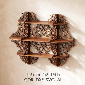 May include: A set of three ceramic mugs with a speckled, cream-colored glaze. Each mug features a different hand-painted floral design in shades of blue, green, and yellow. The mugs have a simple, rounded shape and a comfortable handle.