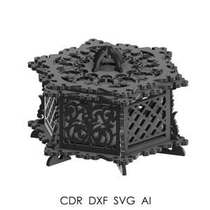 May include: Black laser-cut decorative box with intricate floral and geometric patterns. The box has a hinged lid with a handle and is supported by small feet. The text "CDR DXF SVG AI" is printed at the bottom. The box is likely for storing small items.