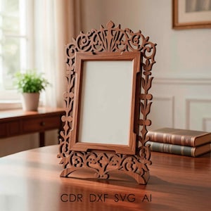 May include: A wooden picture frame with an ornate, carved design. The frame is a warm brown color and features intricate floral and scrollwork patterns. The frame is standing on a table. Text at the bottom reads: CDR DXF SVG AI.
