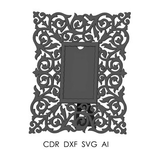 May include: A dark gray, ornate picture frame with a rectangular center and intricate floral and scrollwork design. The frame includes the text "CDR DXF SVG AI" at the bottom, indicating file formats. The frame is suitable for displaying photos or artwork.