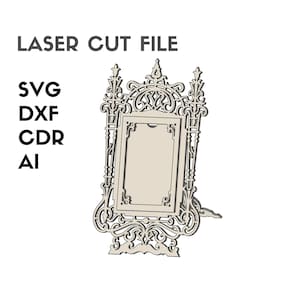 May include: A laser-cut file of an ornate, beige picture frame with detailed scrollwork and a decorative stand. The text "LASER CUT FILE" is at the top, with "SVG, DXF, CDR, AI" listed below. Ideal for crafting projects, this design is ready for cutting.