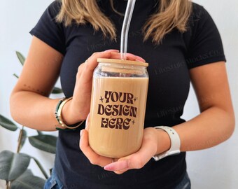 May include: A clear glass tumbler with a bamboo lid and a straw. The tumbler has a brown liquid inside and the text "YOUR DESIGN HERE" printed on the side.