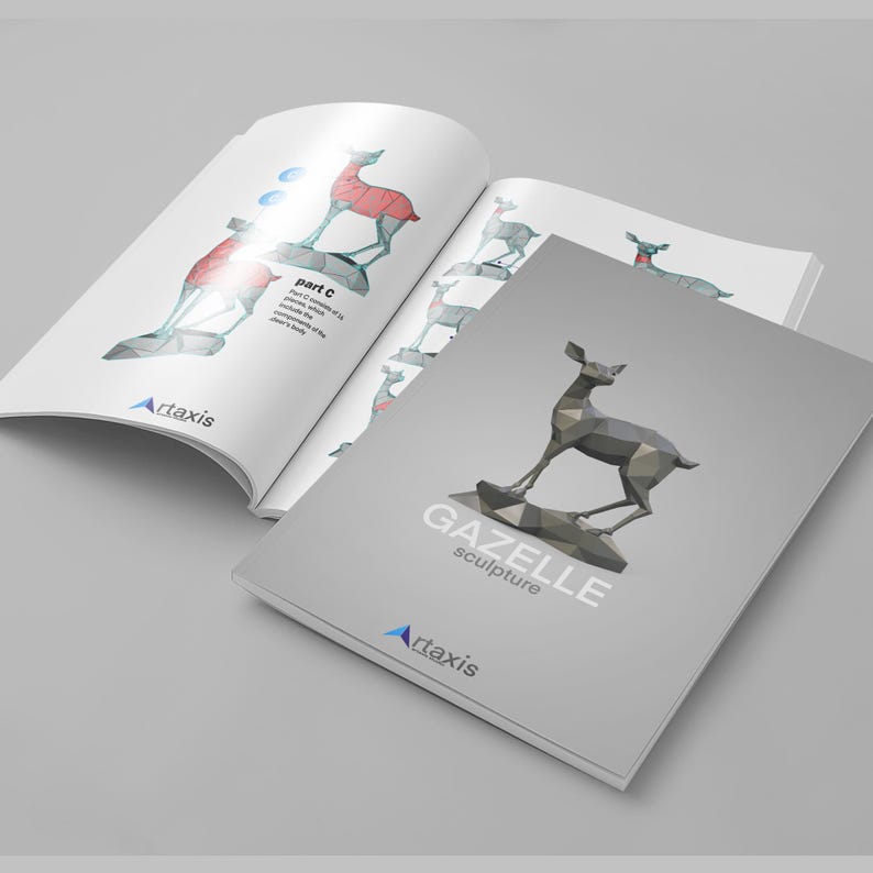 May include: A gray and white booklet with the title "GAZELLE sculpture" and a geometric, polygonal, gray gazelle sculpture on the cover. The booklet is open to a page with a diagram of the gazelle sculpture, showing the different parts of the sculpture.