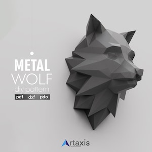 May include: A geometric, dark gray metal wolf head sculpture. The image features the text "METAL WOLF diy pattern" with file format options. The wolf head is a low-poly design, with sharp angles and a modern aesthetic. The artaxis studio logo is in the bottom right.