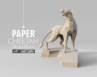 May include: A beige paper cheetah sculpture in a polygonal design, standing on a matching base. The image includes the text "PAPER CHEETAH diy pattern" with file type indicators: pdf, dxf, and pdo. The artaxis studio logo is at the bottom.