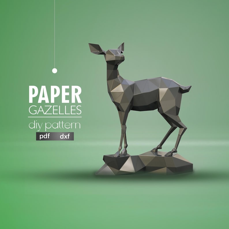 May include: A gray papercraft gazelle model stands on a rocky base. The model is made of folded paper and has a geometric design. The text "PAPER GAZELLES diy pattern pdf dxf" is displayed below the model.