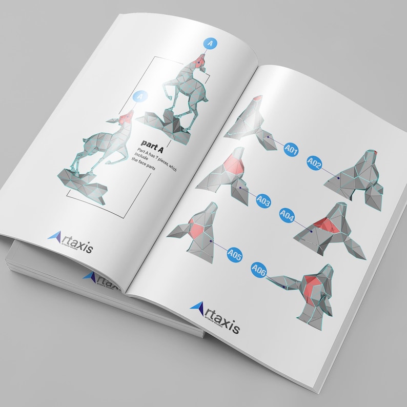 May include: Open book with instructions for assembling a geometric deer sculpture. The instructions show the deer in stages, with labels and diagrams. The "Artaxis" logo is visible on the pages.
