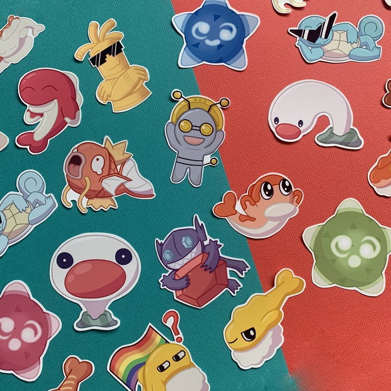 A picture with many stickers on display. Gimmighoul, Gholdengo, Sableye, Minior, Tatsugiri, Wiglett, Squirtle, and Magikarp are all included.