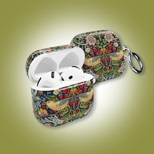 May include: AirPods Pro case with a colorful floral and bird pattern. The case is open, revealing white AirPods. The design features birds, flowers, and berries on a dark blue background. A silver carabiner clip is attached.