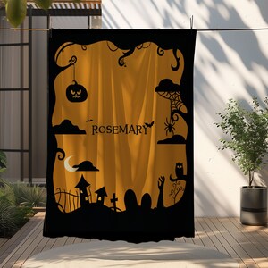 May include: Black and orange Halloween-themed backdrop with a cut-out design featuring a spooky forest, a graveyard, a crescent moon, a spider web, a bat, an owl, and a jack-o-lantern. The backdrop has the name "ROSEMARY" written in the center.