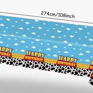 May include: Blue rectangular birthday party tablecloth, 274cm long and 137cm wide, with a sky and cloud pattern. Features a border with a cow print and the words "HAPPY BIRTHDAY".