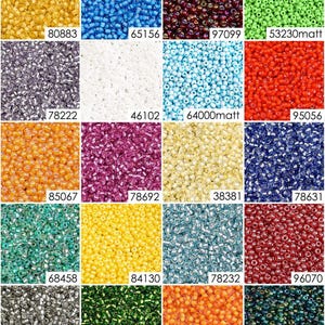 May include: Assortment of 12 small glass seed beads in various colors, including gold, blue, red, green, purple, white, and orange. The beads are arranged in a grid pattern.