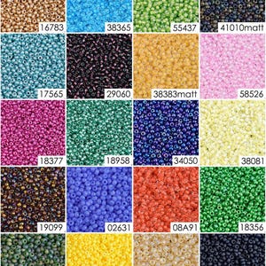 May include: Assortment of 16 different colors of seed beads. Each color is displayed in a square, with the bead count listed below each square.