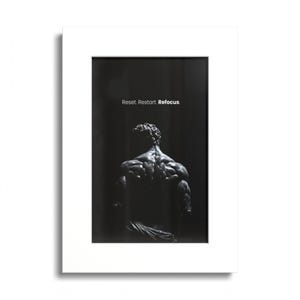 May include: A framed vertical wall art print featuring a black and white photograph of a muscular human back viewed from behind. Above the figure, the text reads Reset. Restart. Refocus. The print is encased in a clean white mat and frame.