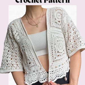 May include: White crochet cardigan with a mandala pattern and beaded trim. The cardigan has a V-neck and is open in the front.  "Bohemian Mandala Crochet Pattern" is written in black text at the top of the image.