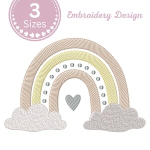 May include: An embroidery design featuring a rainbow with arches in beige, yellow, and a dotted grey line. A grey heart sits centred beneath the rainbow, flanked by two grey clouds. The text 3 Sizes and Embroidery Design is visible.