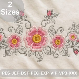 May include: Embroidered floral design featuring pink roses with yellow centers and gray leaves. The design includes buds and scrolling vines. The text "2 Sizes" is in a circle at the top. The bottom of the image has the text "PES-JEF-DST-PEC-EXP-VIP-VP3-XXX".