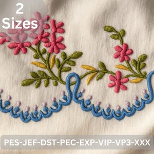 May include: Embroidered floral design featuring pink flowers, green leaves, and a blue decorative border. The text "2 Sizes" is in the upper left corner. The bottom of the image has the text "PES-JEF-DST-PEC-EXP-VIP-VP3-XXX".