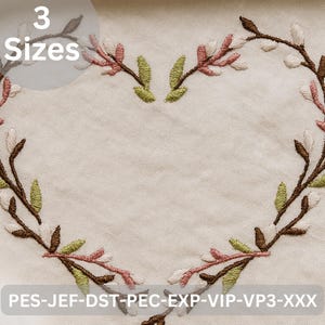 May include: Embroidered heart-shaped design with branches, pink, white, and green leaves, and brown stems. The image includes the text "3 Sizes" and file type codes. The design is on a cream-colored fabric.