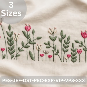 May include: Embroidered floral design featuring pink and cream flowers with green leaves on a cream fabric. The design includes the text "3 Sizes" and the file types: PES-JEF-DST-PEC-EXP-VIP-VP3-XXX. This design is suitable for embroidery projects.