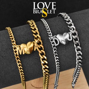 May include: Two curb chain bracelets, one gold-toned and one silver-toned, each featuring a central heart charm split into two halves. The gold bracelet displays the letters M and A, while the silver bracelet displays the letters D and J.